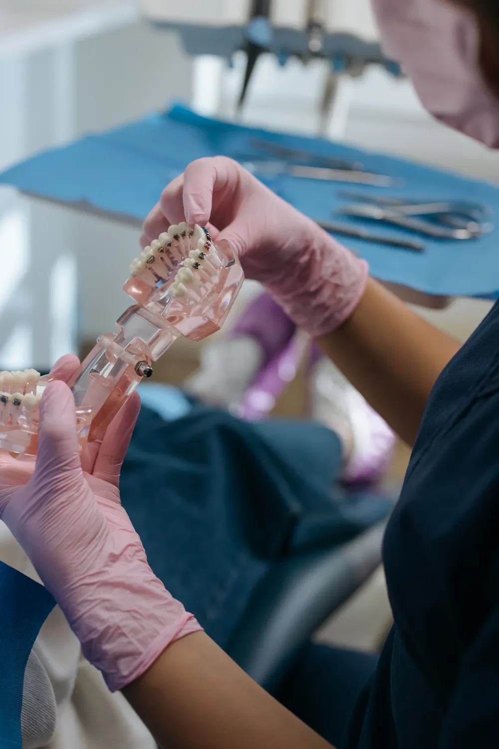 Dental model with metal braces and orthodontic instruments